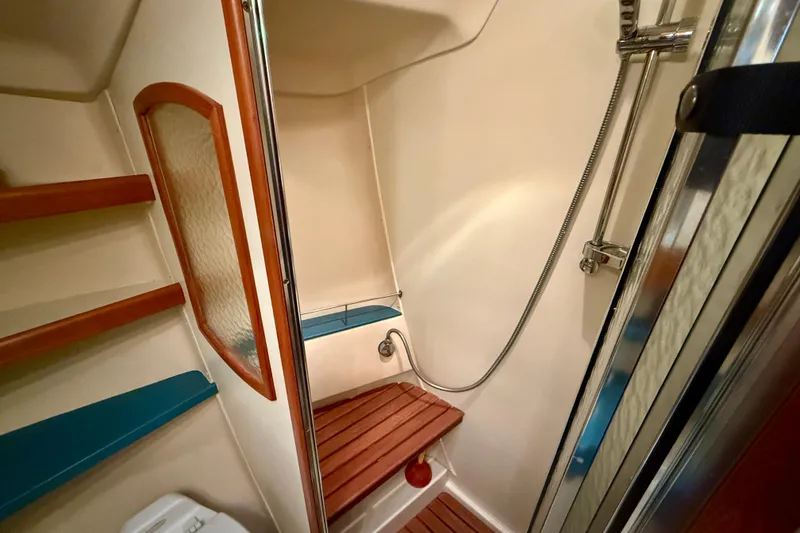 Slide: The Image of Shower area in 2003 Hunter 426 Deck Salon yacht with wooden seat and chrome fixtures. - 24