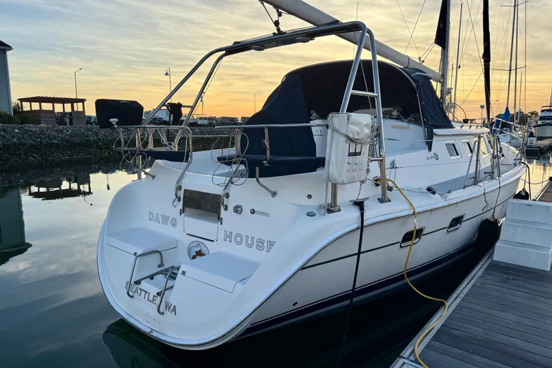 Slide: The Image of Hunter 426 Deck Salon 2003 sailboat docked at sunset, Seattle marina. - 25