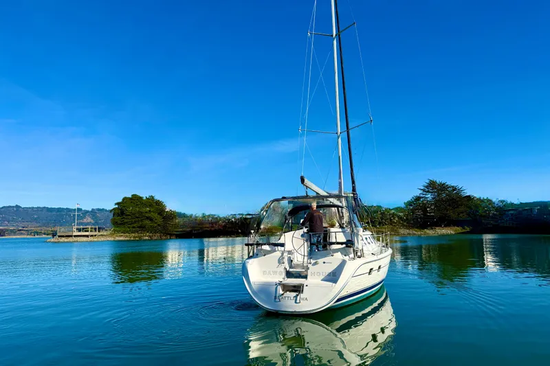 Slide: The Image of 2003 Hunter 426 Deck Salon sailboat on calm water under clear blue sky. - 3
