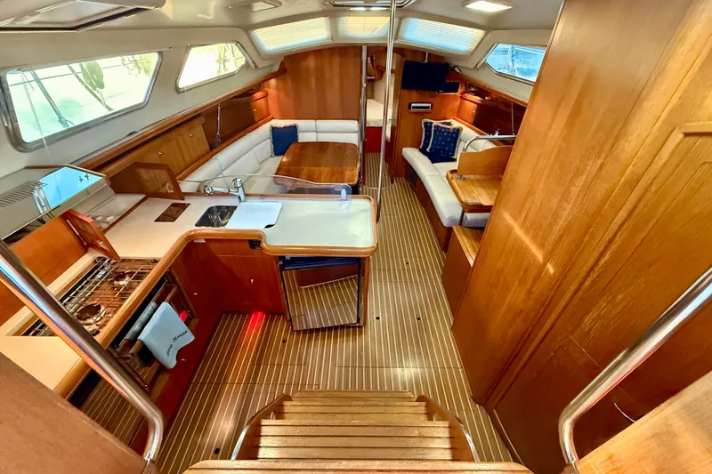 Slide: The Image of Interior of 2003 Hunter 426 Deck Salon yacht with wood finish and seating area. - 7