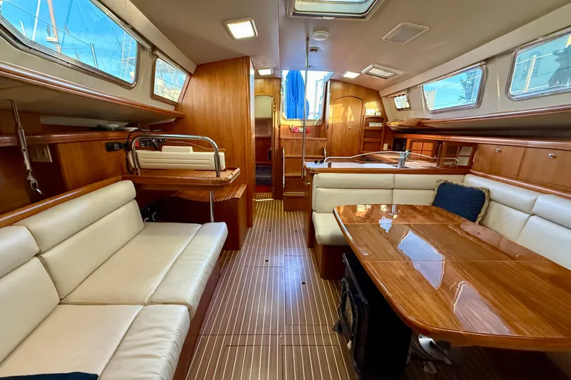 Slide: The Image of Luxurious interior of 2003 Hunter 426 Deck Salon with elegant wood finish and plush seating. - 8