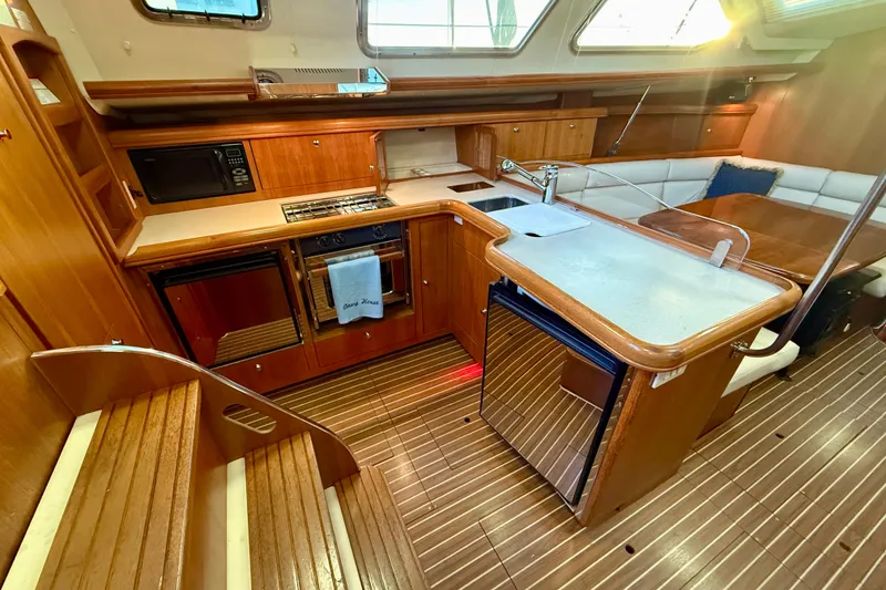Slide: The Image of Luxurious 2003 Hunter 426 Deck Salon interior with modern kitchen and dining area. - 9