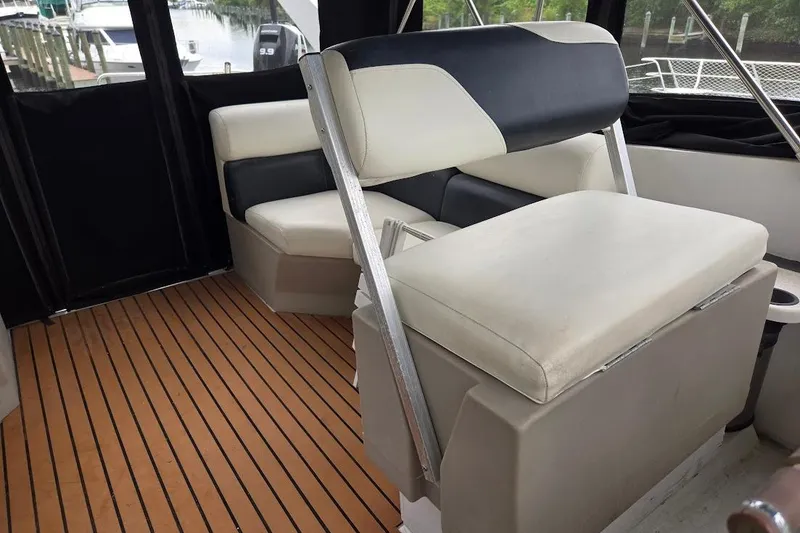 Slide: The Image of 1987 Bayliner 4550 Motoryacht interior with cushioned seating and wood flooring. - 13