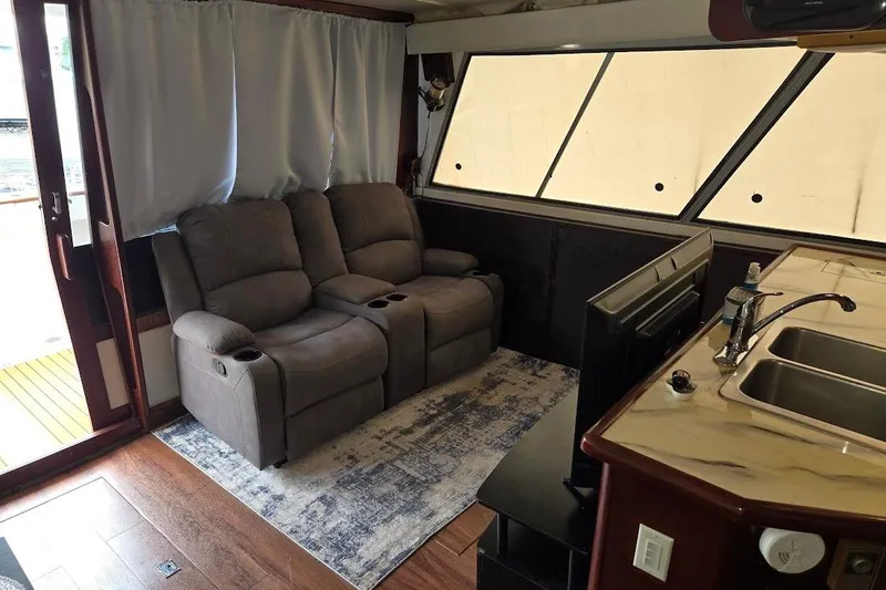 Slide: The Image of Interior of 1987 Bayliner 4550 Motoryacht with recliners, TV, and kitchenette. - 14