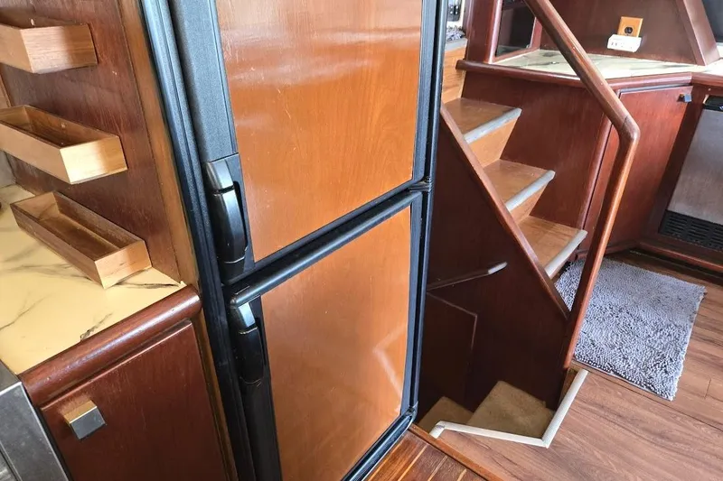Slide: The Image of Interior of 1987 Bayliner 4550 Motoryacht with wooden stairs and refrigerator. - 22