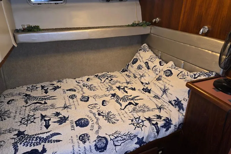 Slide: The Image of Cozy bedroom in 1987 Bayliner 4550 Motoryacht with nautical-themed bedding. - 35