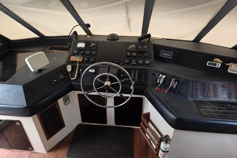 Slide: The Image of Cockpit of 1987 Bayliner 4550 Motoryacht with steering wheel and control panels. - 43