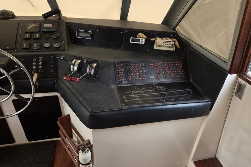 Slide: The Image of 1987 Bayliner 4550 Motoryacht helm with control panel and steering wheel. - 44