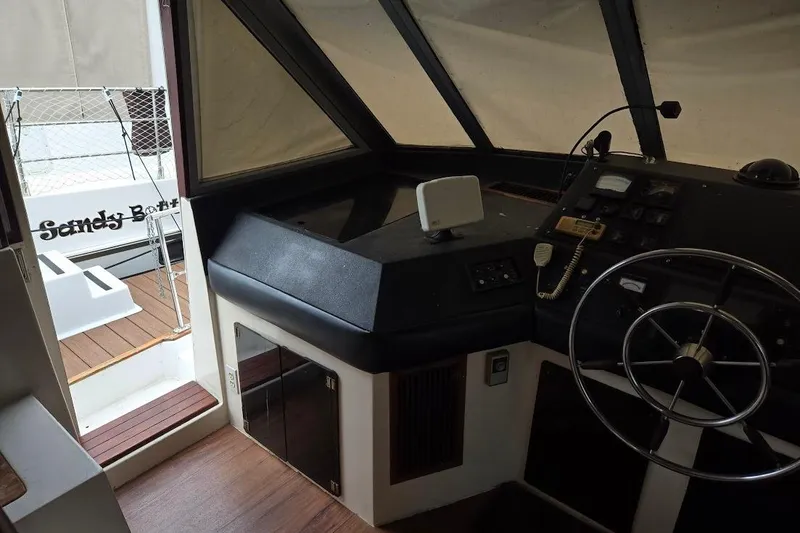 Slide: The Image of Interior helm of 1987 Bayliner 4550 Motoryacht with steering wheel and control panel. - 45
