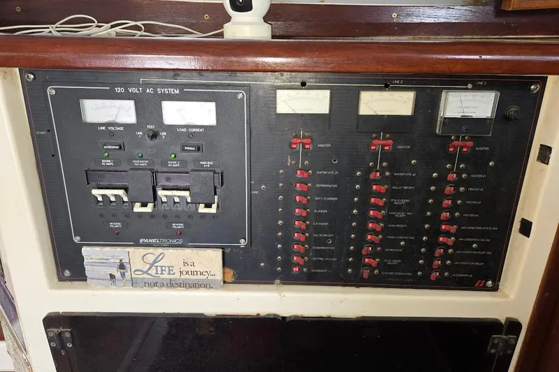 Slide: The Image of Electrical panel of a 1987 Bayliner 4550 Motoryacht with various switches and meters. - 46