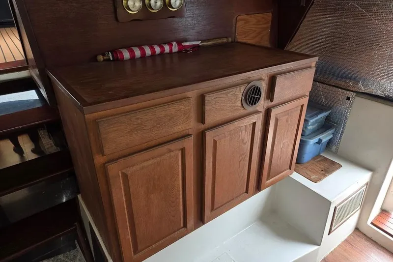 Slide: The Image of 1987 Bayliner 4550 Motoryacht interior with wooden cabinetry and nautical decor. - 49