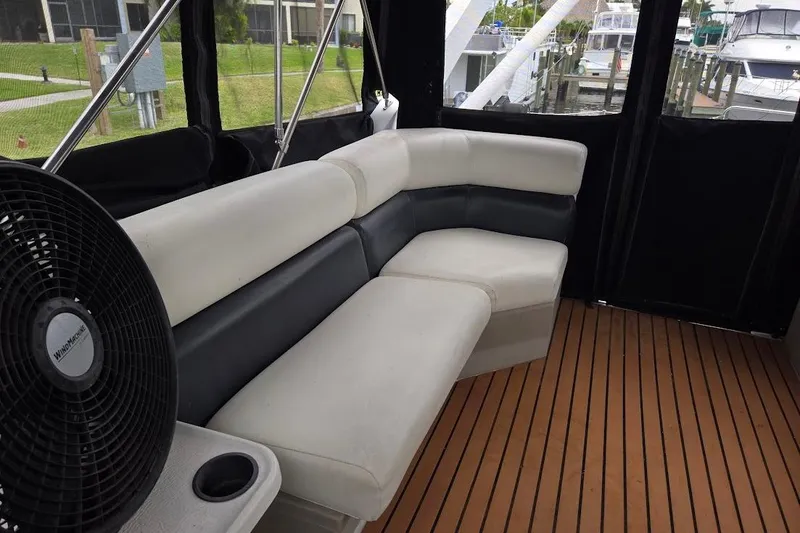 Slide: The Image of 1987 Bayliner 4550 Motoryacht interior with cushioned seating and wooden flooring. - 50