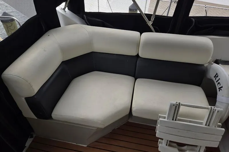 Slide: The Image of 1987 Bayliner 4550 Motoryacht interior with white and black cushioned seating. - 53
