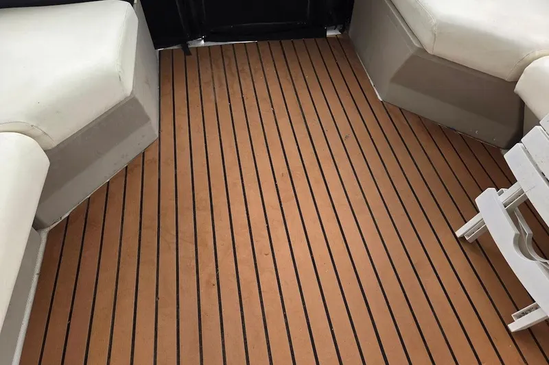 Slide: The Image of 1987 Bayliner 4550 Motoryacht deck with cushioned seating and wooden flooring. - 54