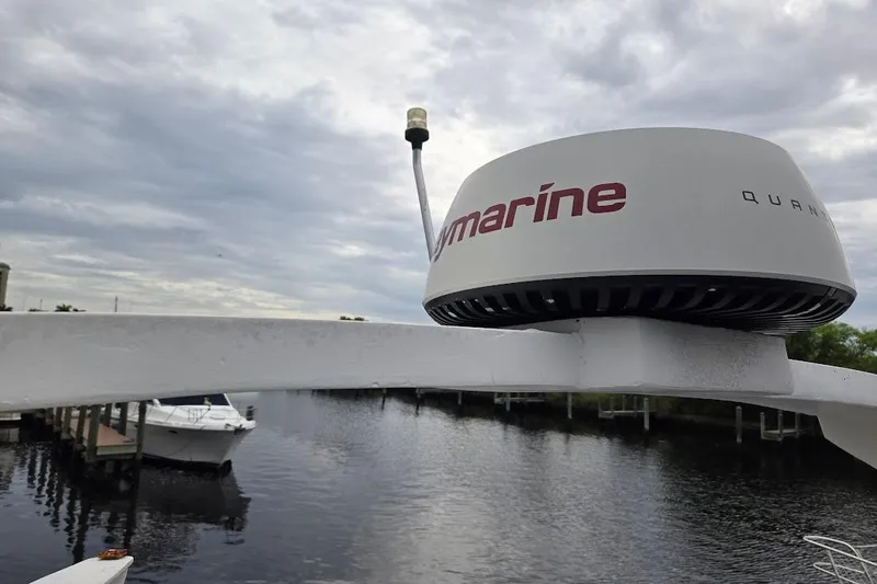 Slide: The Image of Bayliner 4550 Motoryacht 1987 with Raymarine radar on a cloudy day by the water. - 58