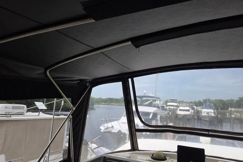 Slide: The Image of 1987 Bayliner 4550 Motoryacht interior view with marina backdrop. - 61