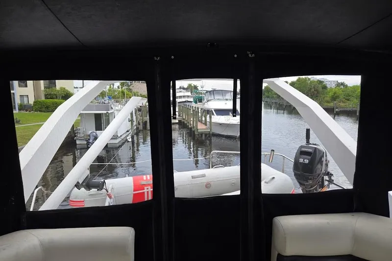 Slide: The Image of View from 1987 Bayliner 4550 Motoryacht interior, overlooking marina with boats and inflatable dinghy. - 62