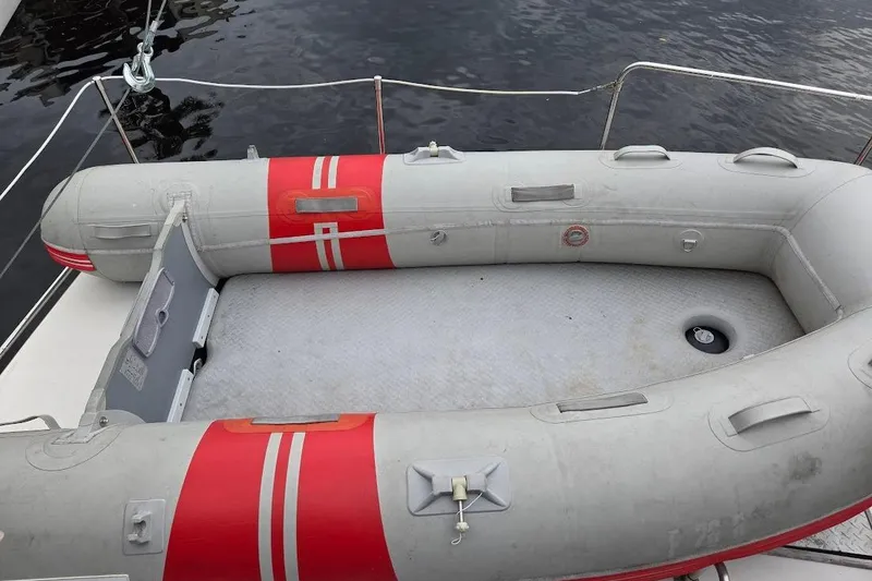 Slide: The Image of Inflatable dinghy on 1987 Bayliner 4550 Motoryacht, docked on calm water. - 63