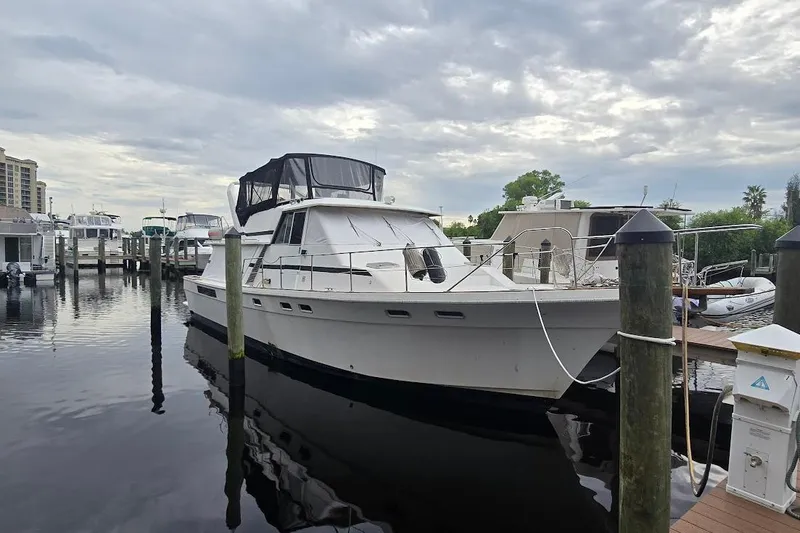 Slide: The Image of 1987 Bayliner 4550 Motoryacht docked at a marina under cloudy skies. - 72