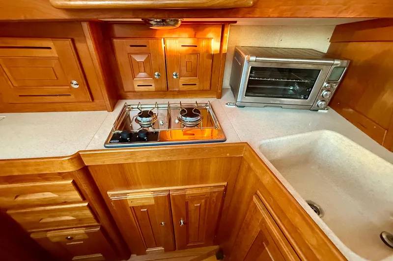 Slide: The Image of Wooden kitchen interior of 2015 Tartan 4000 with stove, oven, and sink. - 13
