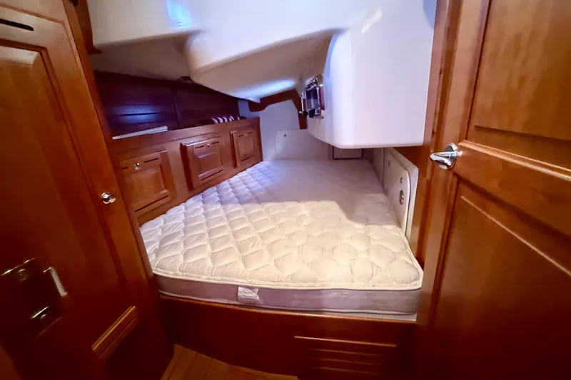 Slide: The Image of Cozy cabin interior of 2015 Tartan 4000 sailboat with wooden cabinetry and comfortable mattress. - 18