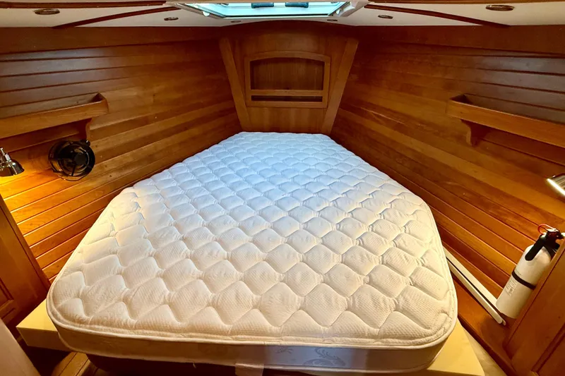 Slide: The Image of Cozy cabin interior of 2015 Tartan 4000 yacht with wooden walls and comfortable bed. - 22