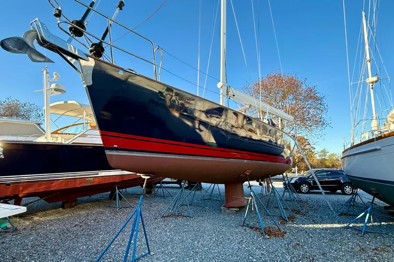 Slide: The Image of Sailboat Tartan 4000, 2015 model, on stands in a boatyard under clear blue sky. - 7