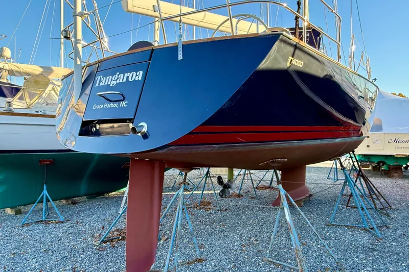 Slide: The Image of Tartan 4000 sailboat from 2015 on stands, named Tangaroa, in a boatyard. - 8