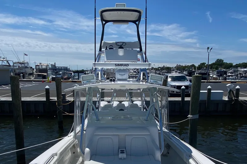 Slide: The Image of 2016 Regulator 41 boat docked at marina, featuring Simrad electronics and a clear blue sky. - 12