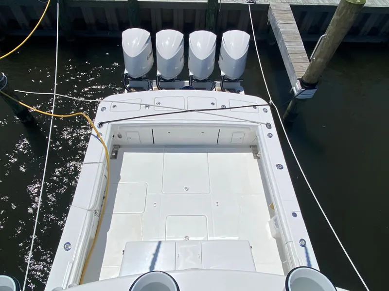 Slide: The Image of 2016 Regulator 41 boat with four outboard engines docked at a marina. - 23