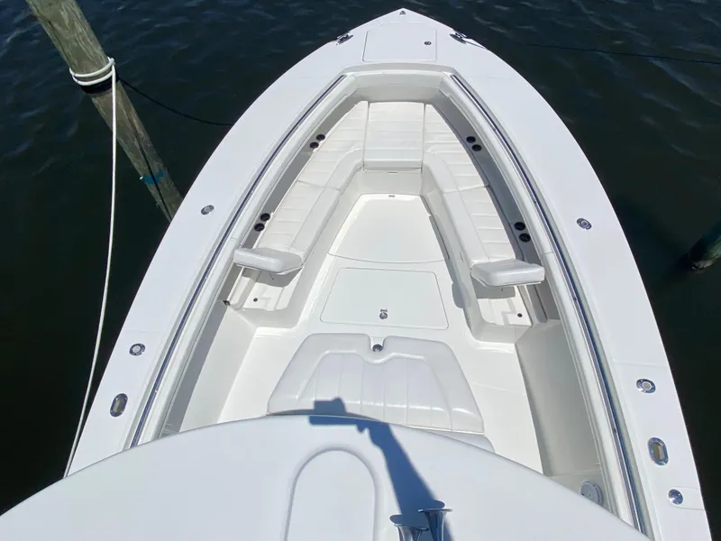 Slide: The Image of 2016 Regulator 41 boat bow with white seating, docked on calm water. - 24