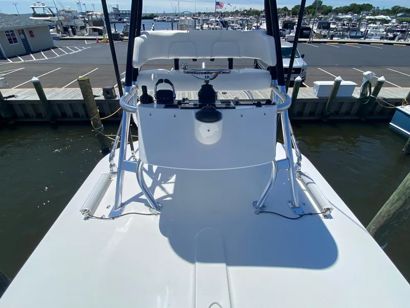 Slide: The Image of 2016 Regulator 41 boat helm at dock, showcasing controls and seating. - 26