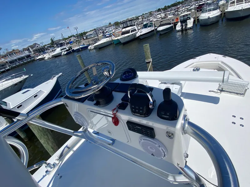 Slide: The Image of Helm of 2016 Regulator 41 boat docked at marina with other vessels. - 27