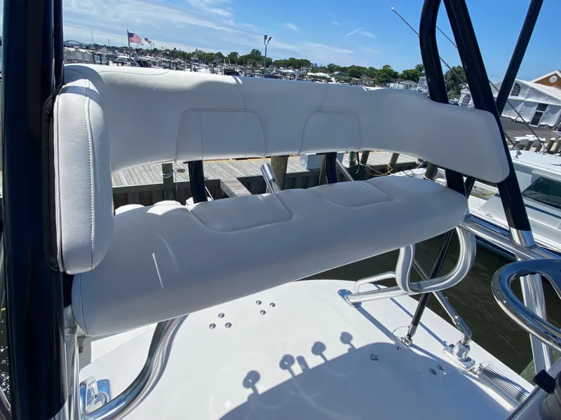 Slide: The Image of 2016 Regulator 41 boat with white seating, docked at a marina under a clear blue sky. - 29