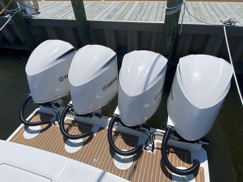 Slide: The Image of Four Yamaha outboard engines on a 2016 Regulator 41 boat at a dock. - 32