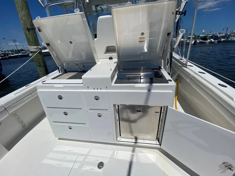 Slide: The Image of 2016 Regulator 41 boat with open storage compartments and stainless steel features. - 37