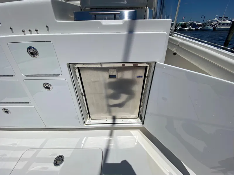 Slide: The Image of 2016 Regulator 41 boat storage compartment with open hatch, docked at marina. - 38