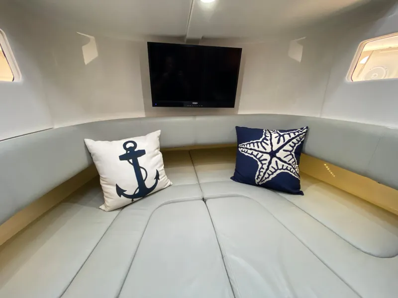 Slide: The Image of Interior of 2016 Regulator 41 boat with cozy seating and nautical-themed pillows. - 44