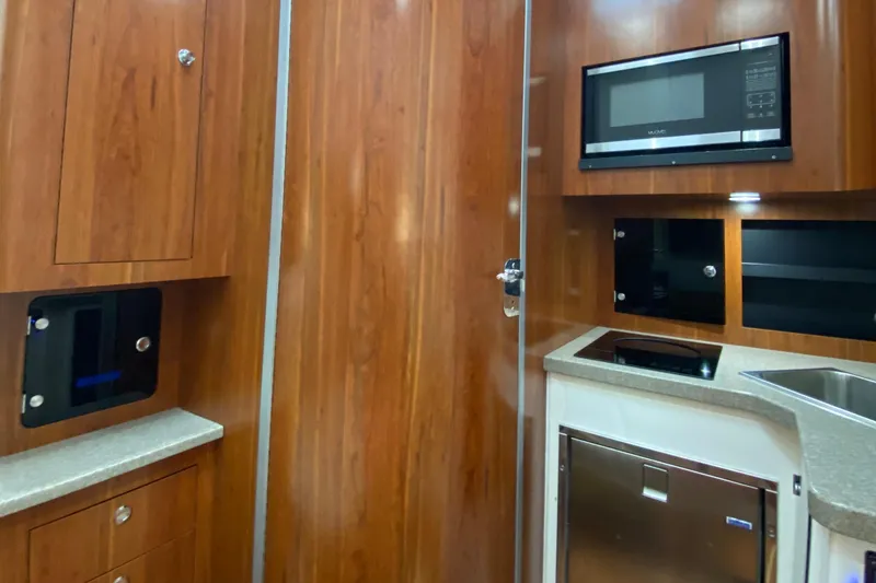 Slide: The Image of 2016 Regulator 41 interior with wood cabinetry, microwave, and modern kitchen amenities. - 49