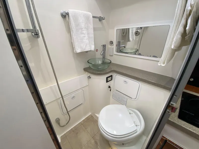 Slide: The Image of Compact bathroom in 2016 Regulator 41 boat with modern fixtures and glass sink. - 51