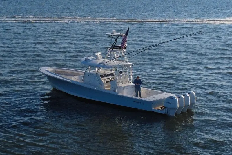 Slide: The Image of 2016 Regulator 41 boat on open water with fishing rods and American flag. - 64