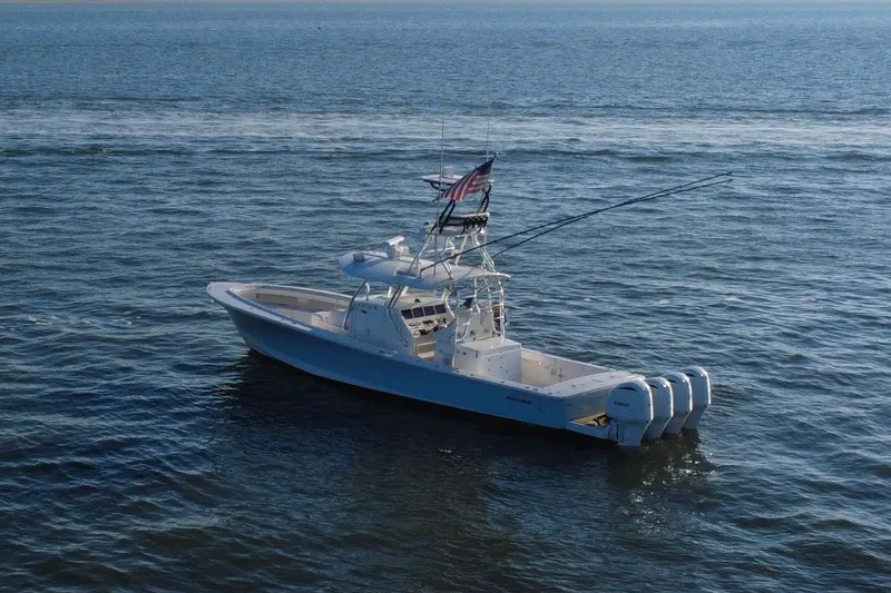 Slide: The Image of 2016 Regulator 41 boat on open water with fishing rods and American flag. - 66