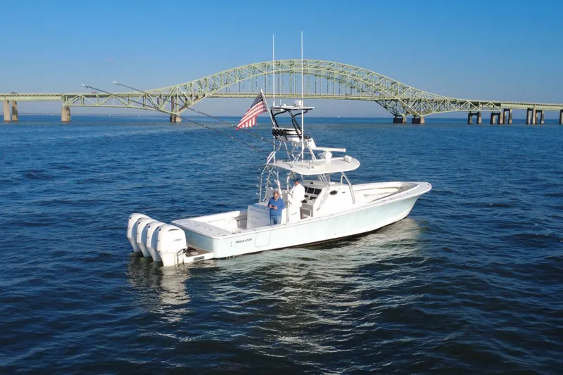 Slide: The Image of 2016 Regulator 41 boat on water near a large bridge, clear blue sky. - 67