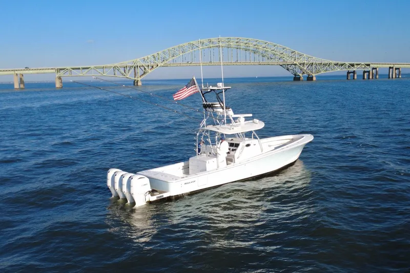 Slide: The Image of 2016 Regulator 41 boat on water near a large bridge, clear blue sky. - 68