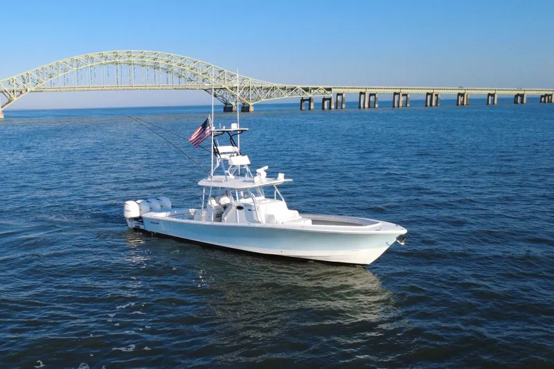 Slide: The Image of 2016 Regulator 41 boat on water near a large bridge, clear blue sky. - 70