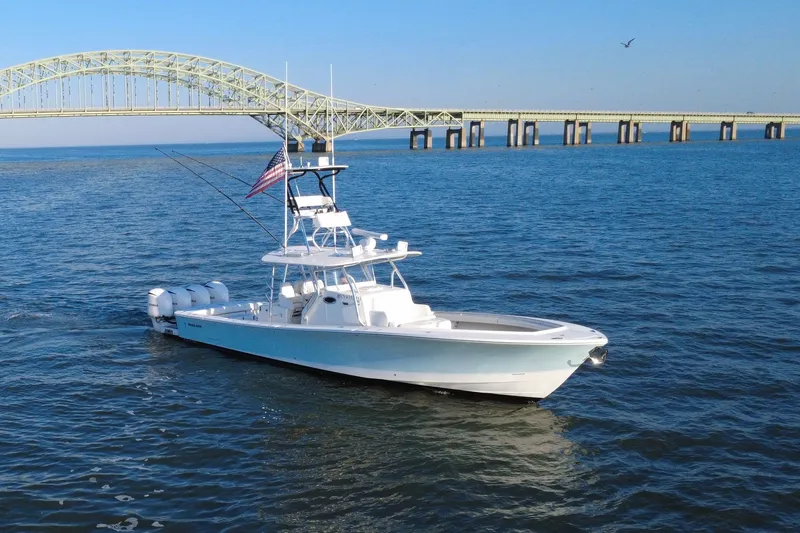 Slide: The Image of 2016 Regulator 41 boat cruising near a bridge on a sunny day. - 71