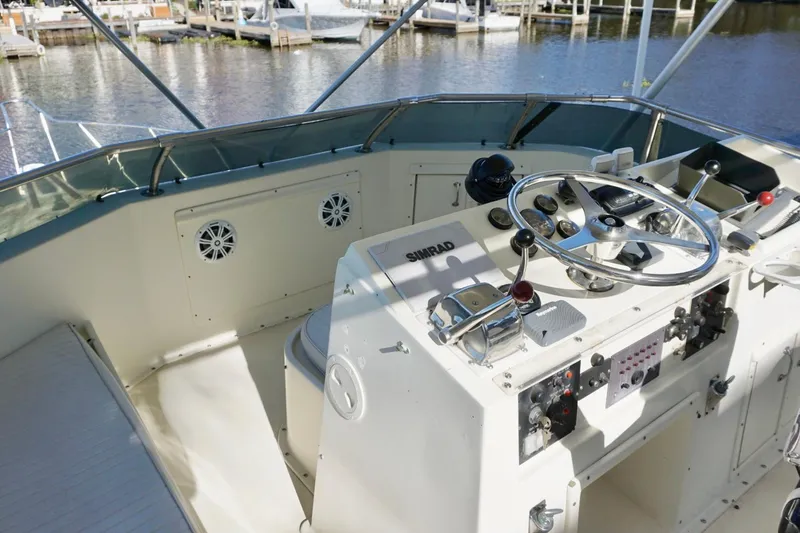 Slide: The Image of 1986 Hatteras 41 Convertible boat helm with steering wheel and controls. - 11