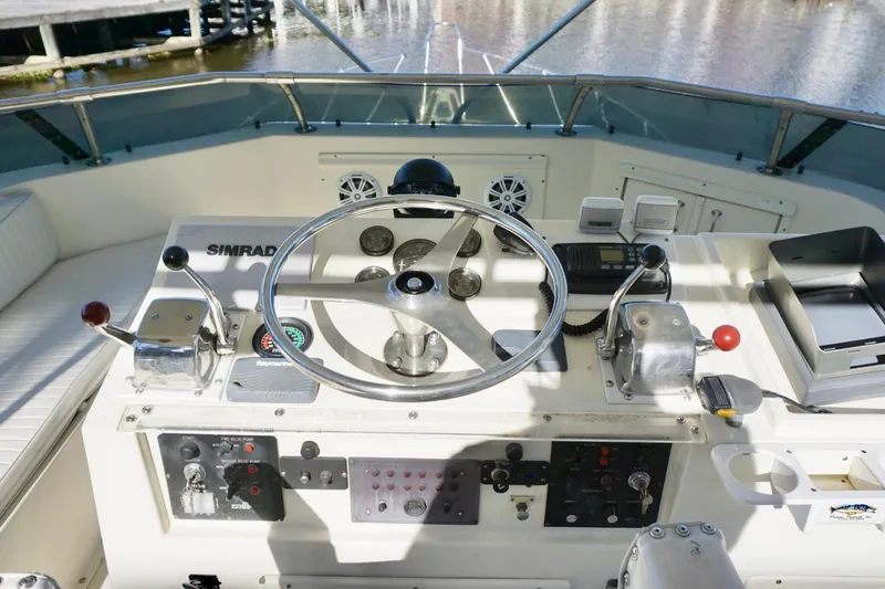 Slide: The Image of Cockpit of 1986 Hatteras 41 Convertible boat with steering wheel and controls. - 14