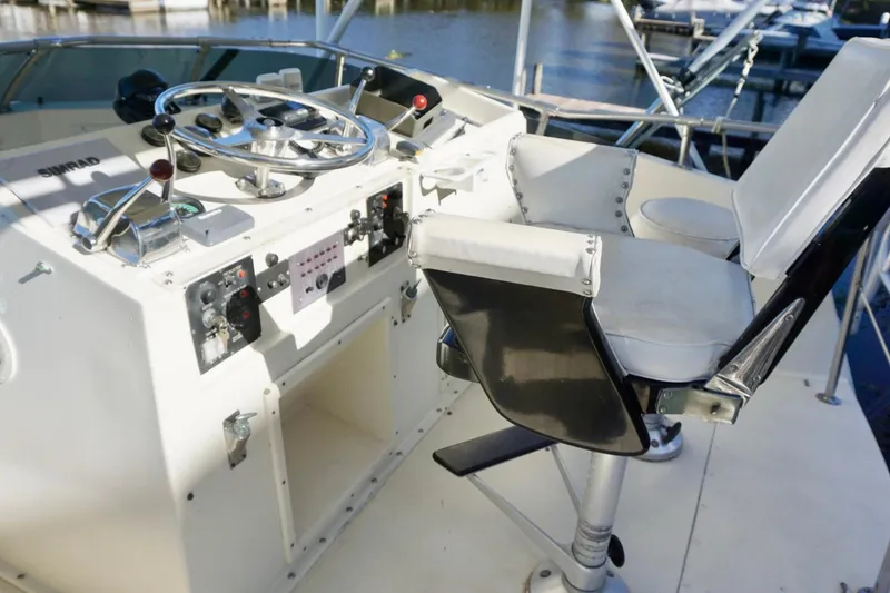 Slide: The Image of 1986 Hatteras 41 Convertible helm with steering wheel and captain's chair. - 15