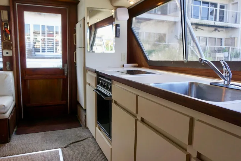 Slide: The Image of Interior of 1986 Hatteras 41 Convertible yacht with kitchen and seating area. - 27